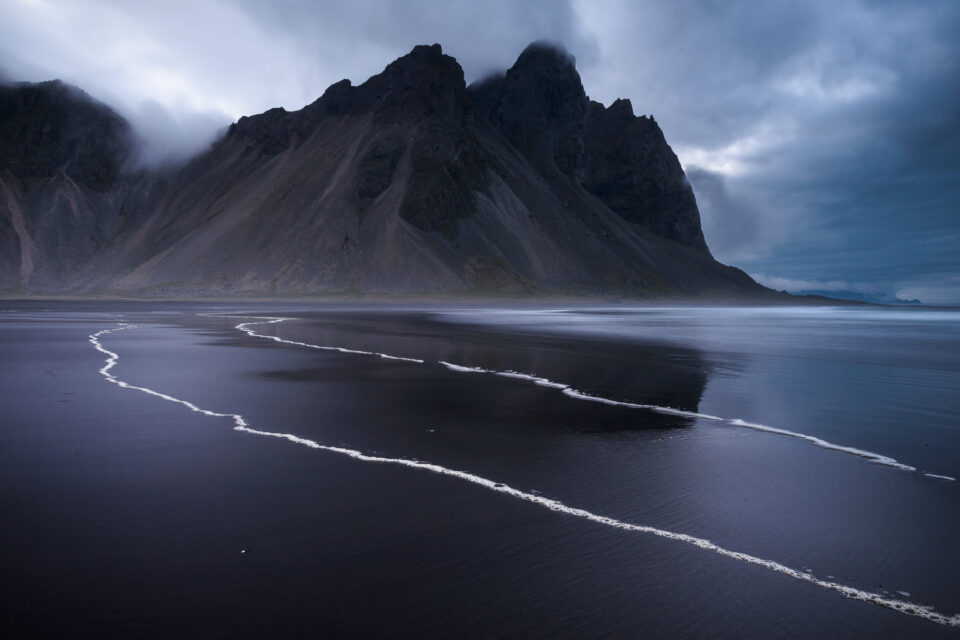 This landscape photo is so intense because of the dark blue lighting and high contrast.